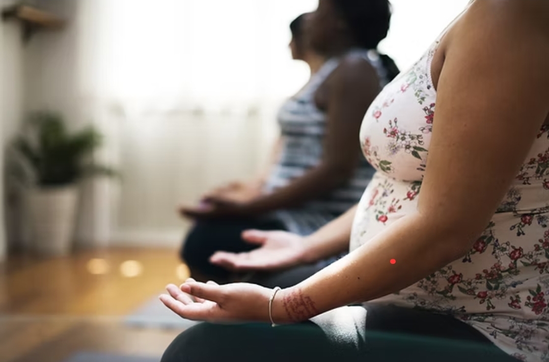 Mothers practicing quiet, mindful breathing together