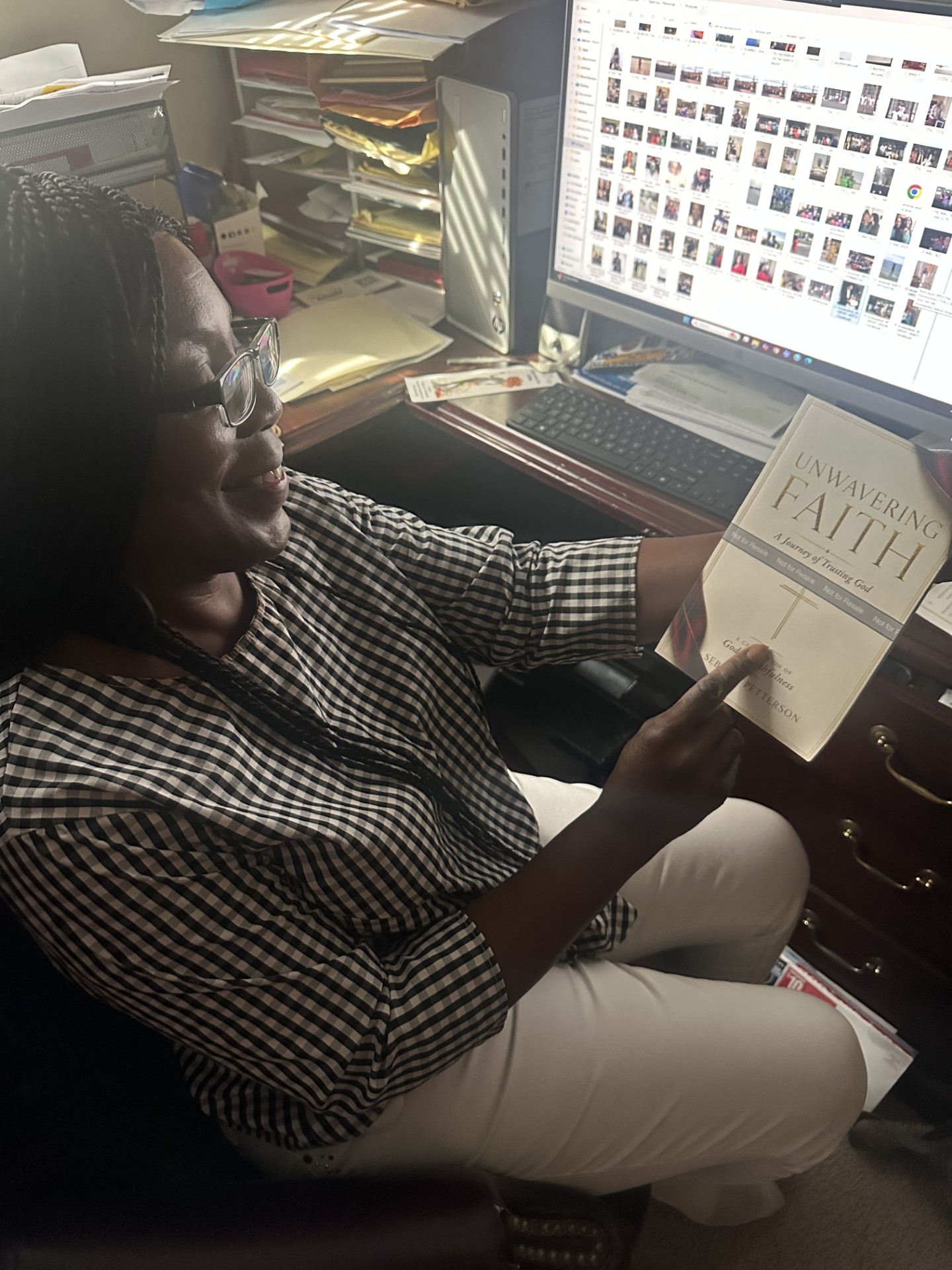 Sebrina Petterson holding the first physical proof copy of Unwavering Faith
