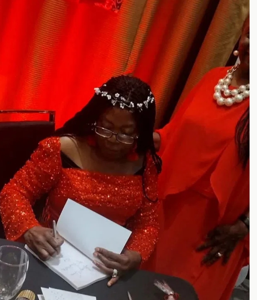 Sebrina Petterson signing copies of Unwavering Faith at her book release celebration